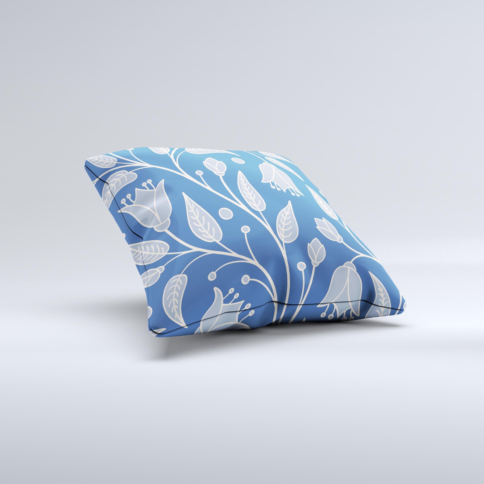 White and blue decorative throw pillow featuring vector branches design, handcrafted in Virginia.