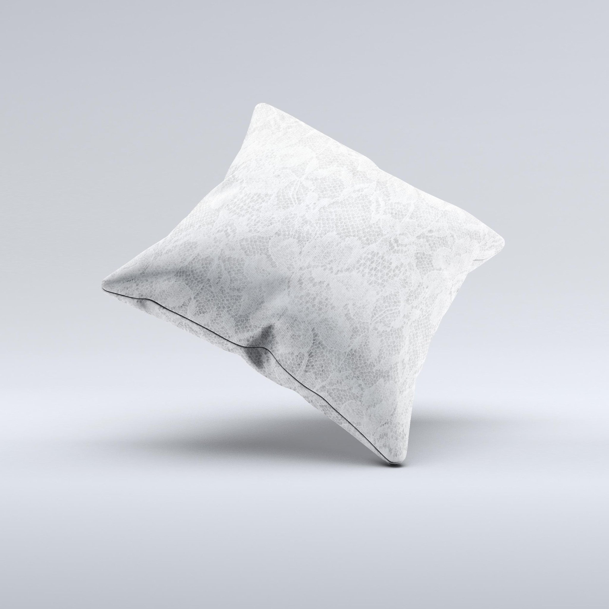 A beautifully handcrafted white textured lace decorative throw pillow with intricate ink-fuzed design, showcasing its unique and artisanal quality.