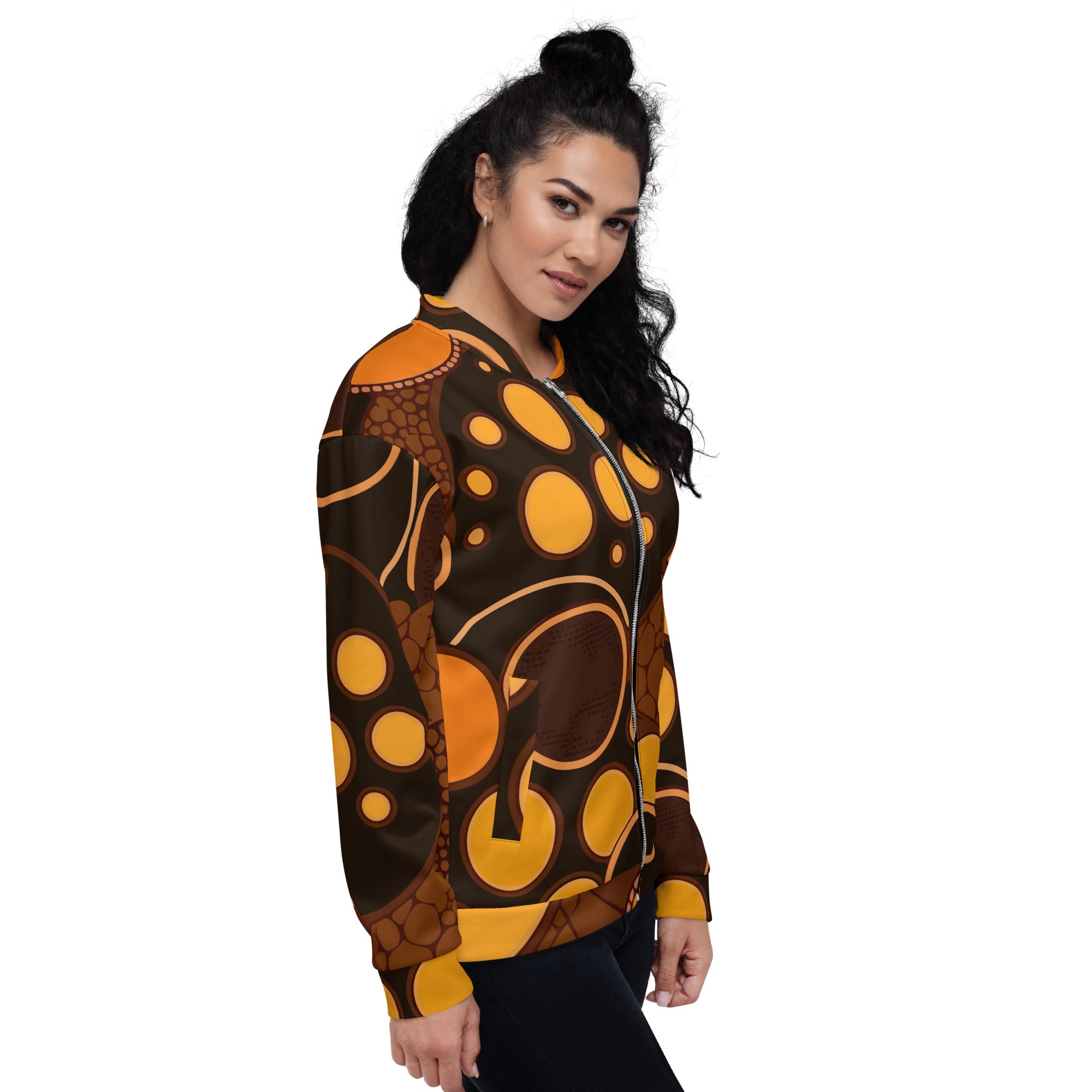 Women's bomber jacket featuring an orange and brown spotted print, zip-front closure, and ribbed cuffs, perfect for stylish layering.
