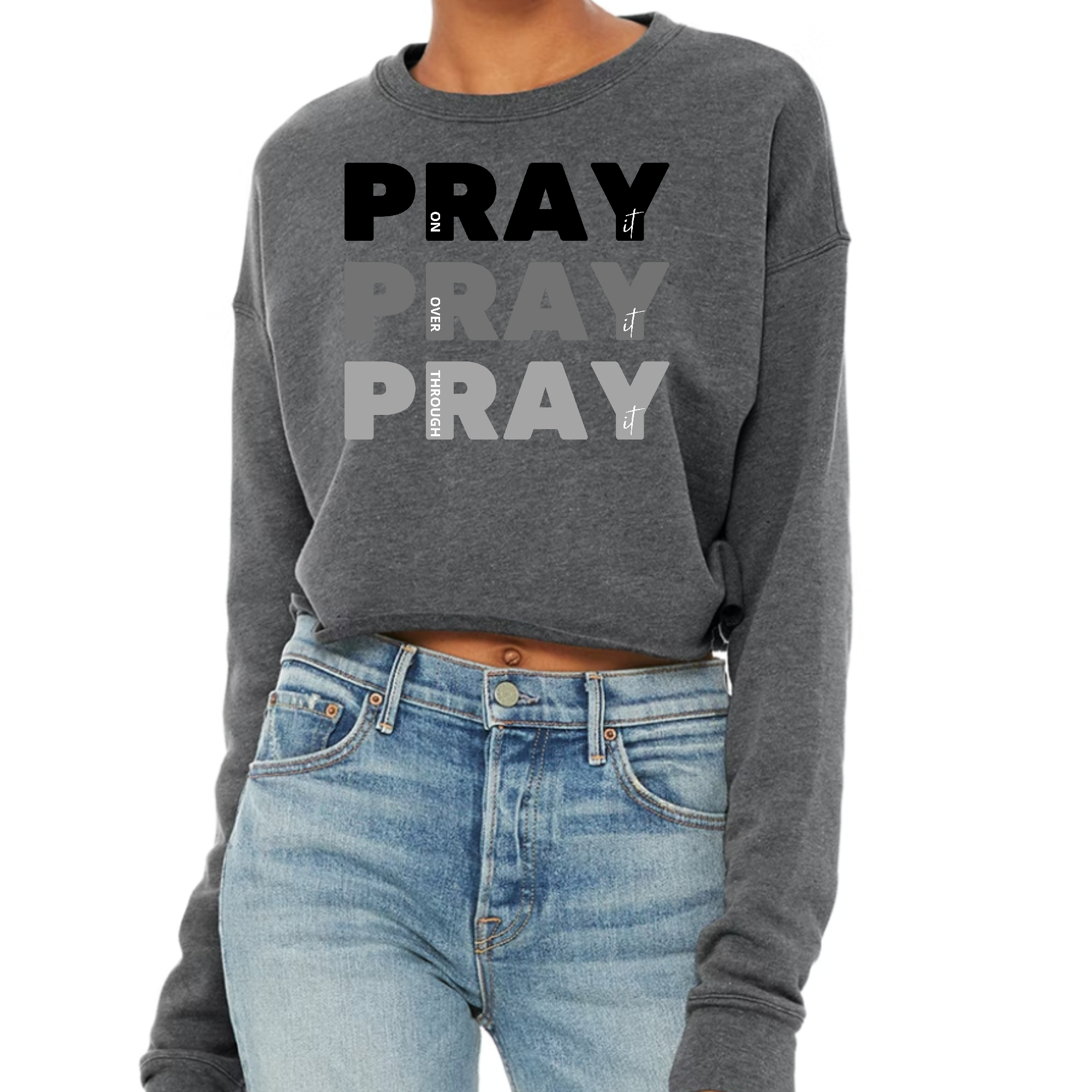 Women's cropped graphic sweatshirt in black featuring 'Pray On It Over It Through It' print, showcasing a relaxed fit and long sleeves.