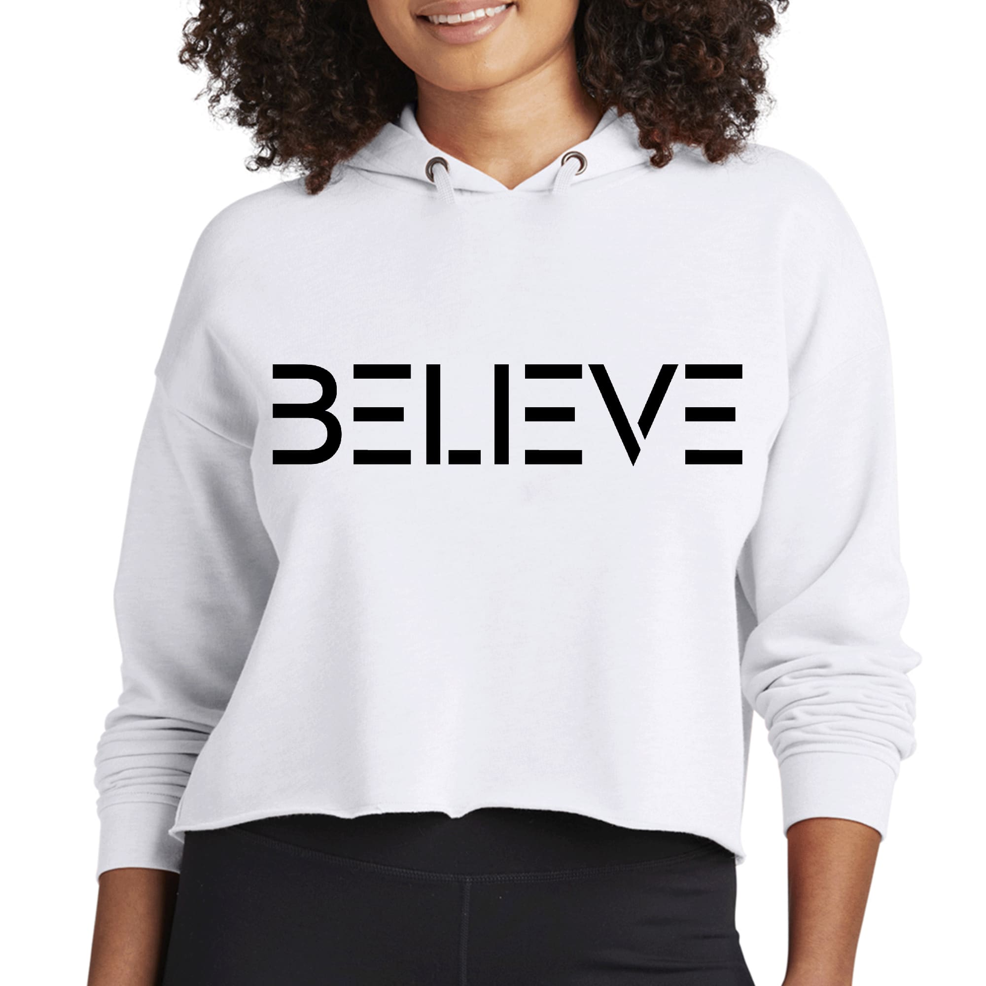 Women's cropped hoodie featuring 'Believe' black print, showcasing a relaxed fit and soft fabric.