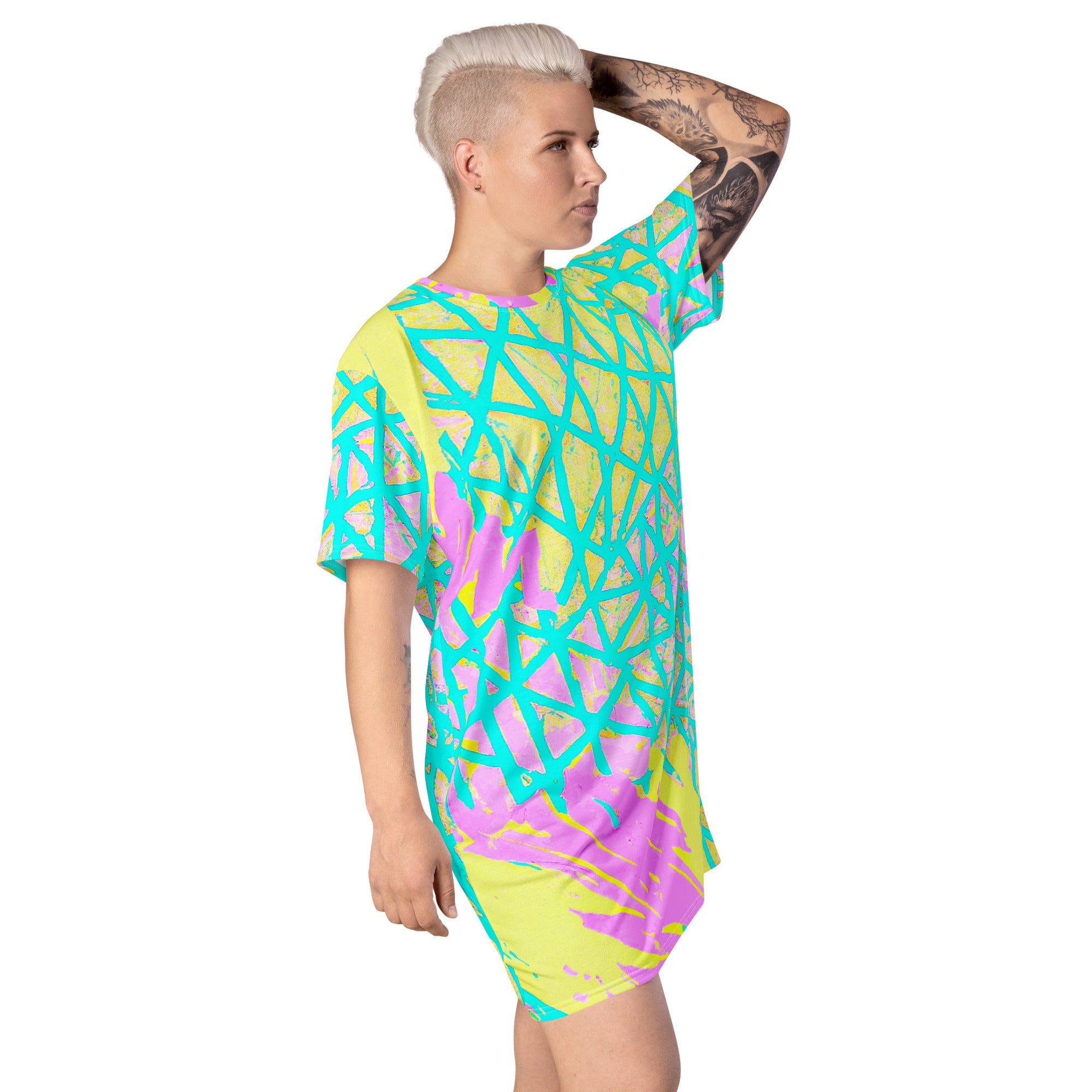 Womens Graphic T-shirt Dress featuring a vibrant cyan blue, lime green, and pink pattern, showcasing its comfortable oversize fit and stylish design.