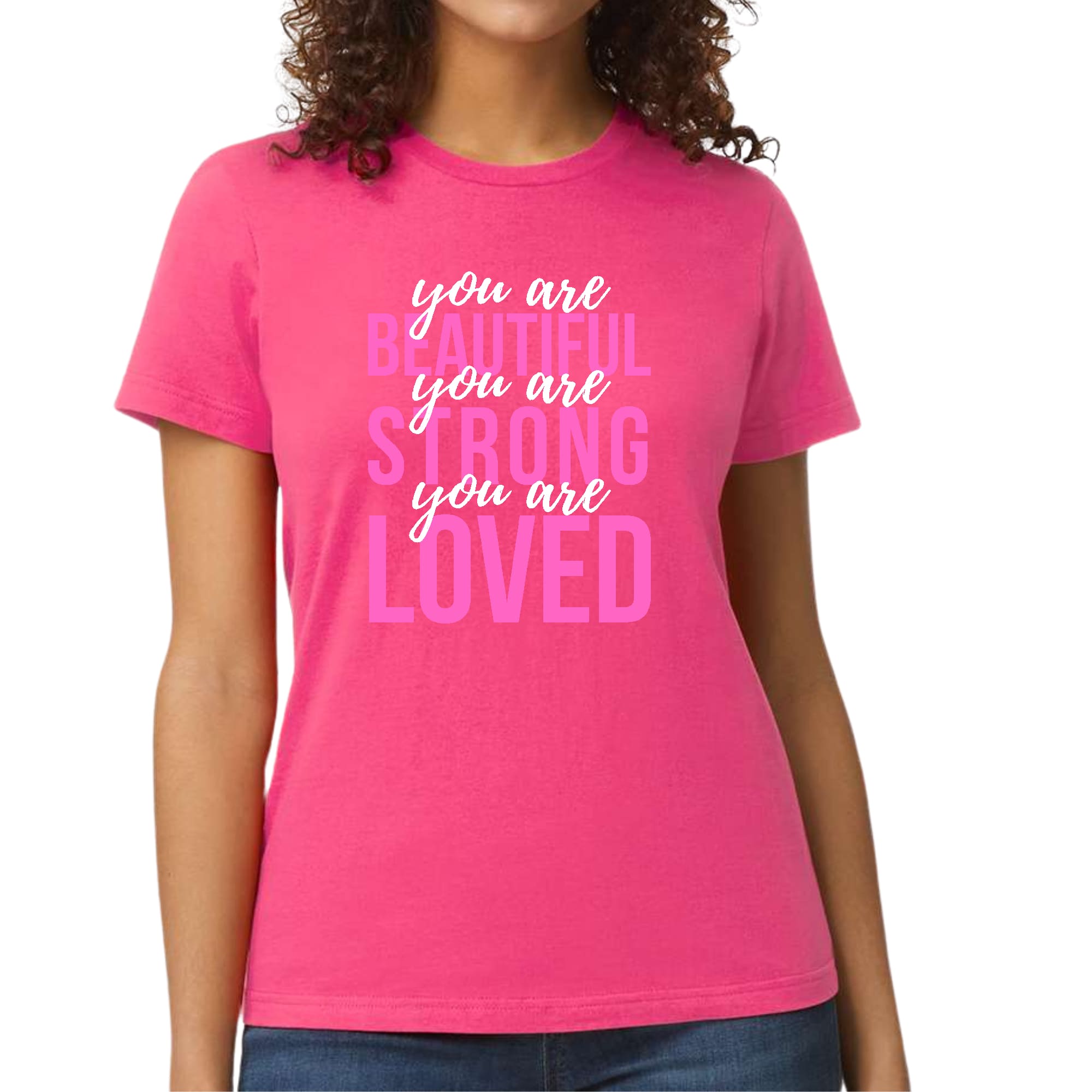 A pink and white women's graphic T-shirt with the inspirational text 'You Are Beautiful Strong Loved' printed on it, showcasing a comfortable and stylish design.