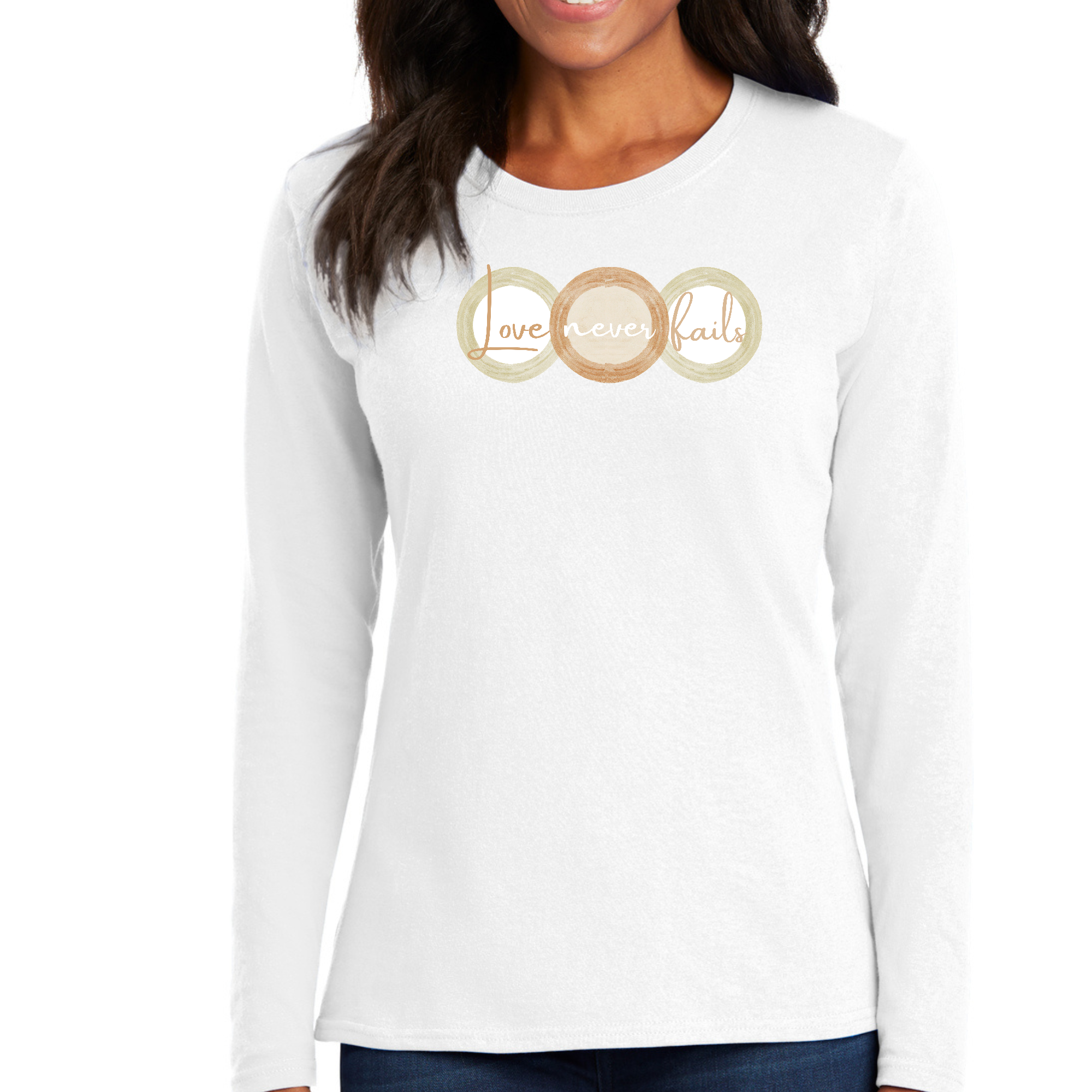 Womens Long Sleeve Graphic T-shirt in pastel brown featuring 'Love Never Fails' design with circular shapes in beige and green.