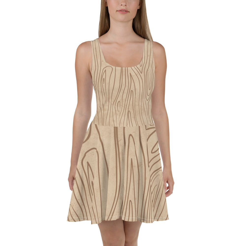 A stylish women's skater dress featuring a beige and brown tree sketch design, showcasing a flattering A-line silhouette and sleeveless style.