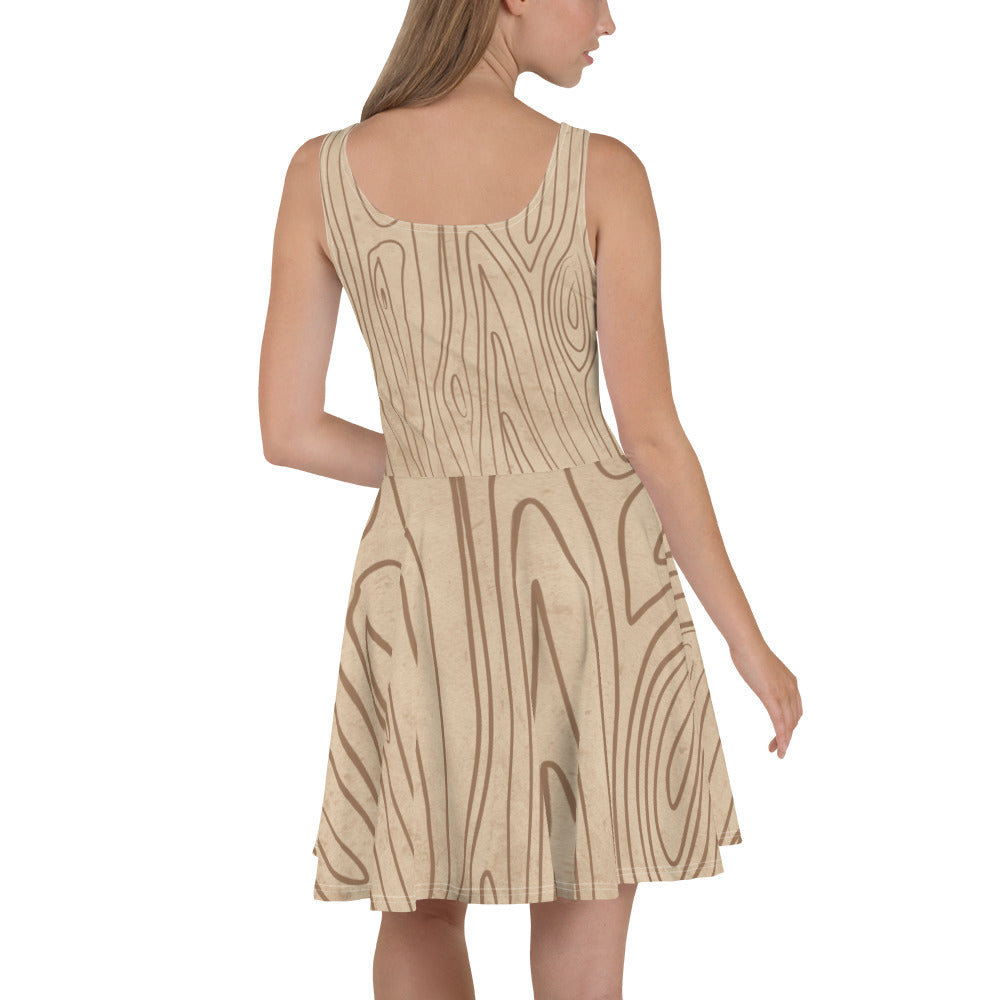 A stylish women's skater dress featuring a beige and brown tree sketch design, showcasing a flattering A-line silhouette and sleeveless style.