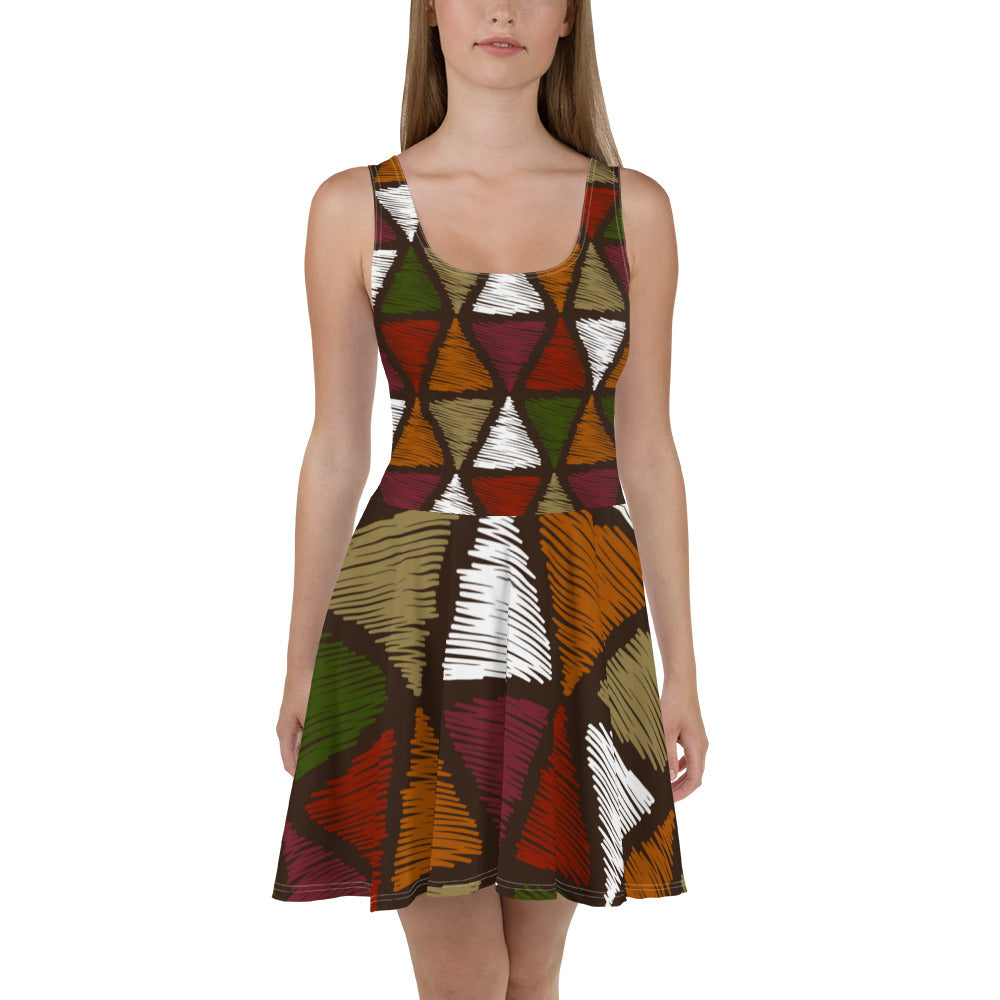 A vibrant Women's Skater Dress featuring red and green geometric lines, showcasing a flattering A-line silhouette and sleeveless design.