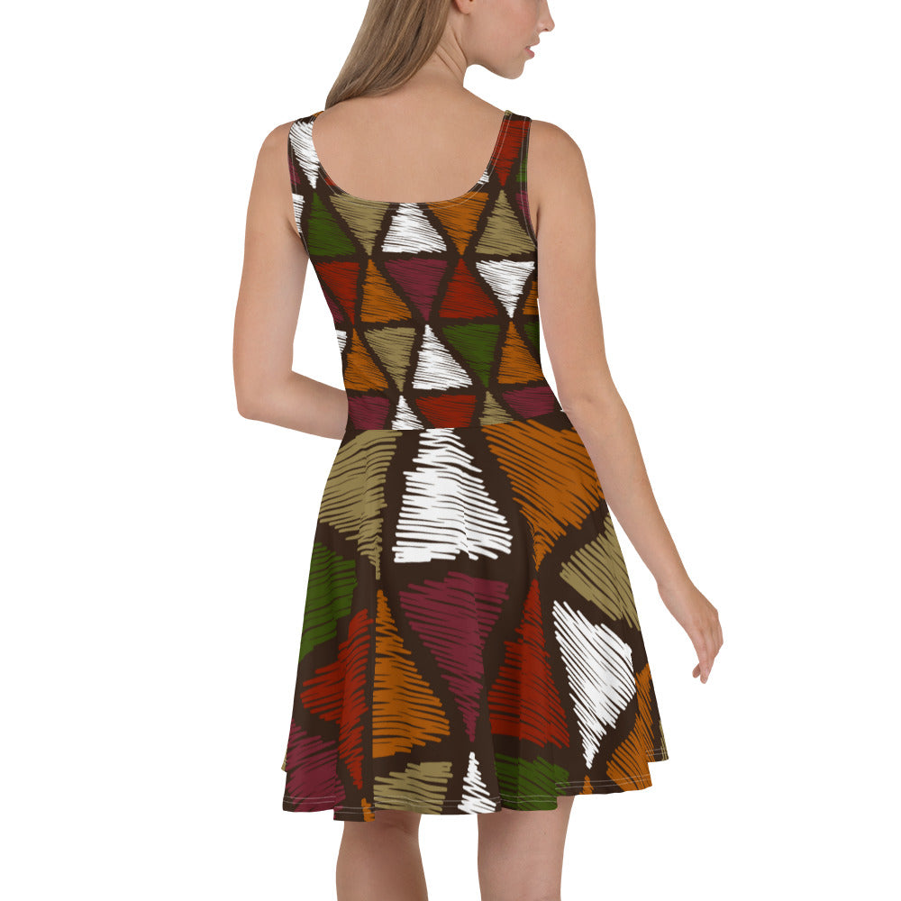 A vibrant Women's Skater Dress featuring red and green geometric lines, showcasing a flattering A-line silhouette and sleeveless design.