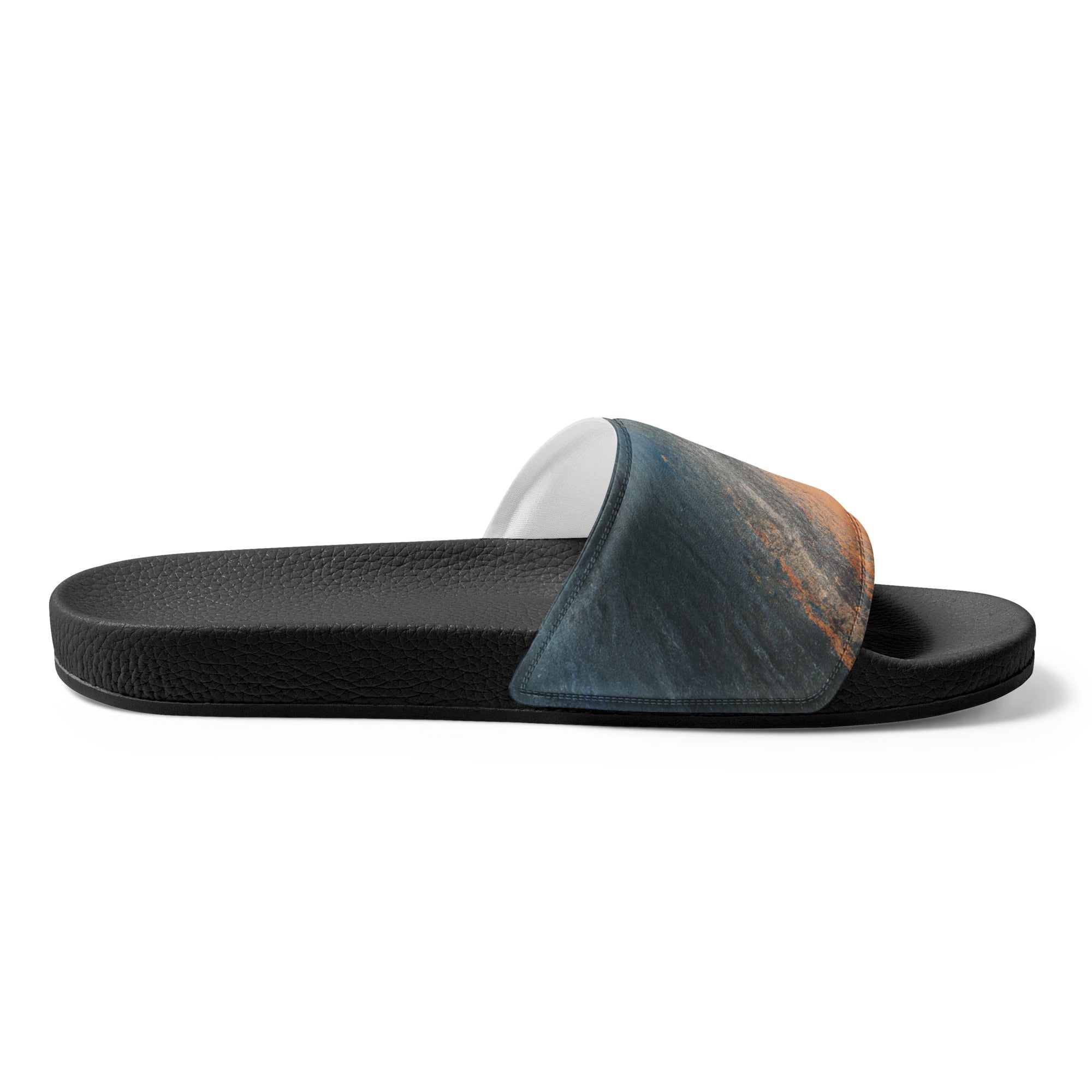 A pair of women's slides featuring an abstract blue, orange, and grey pattern, designed for comfort and style.