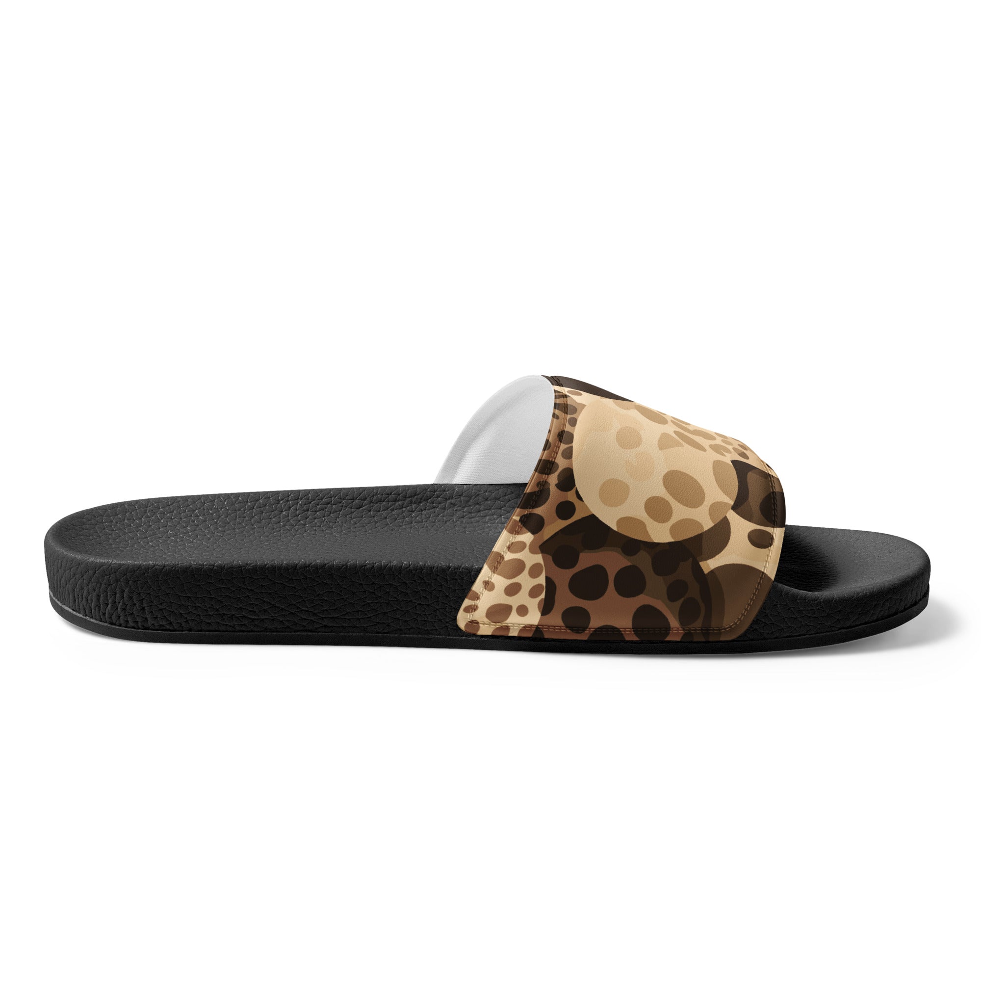 A pair of women's slides featuring a beige and brown leopard spots illustration, showcasing a cushioned upper strap and textured footbed.