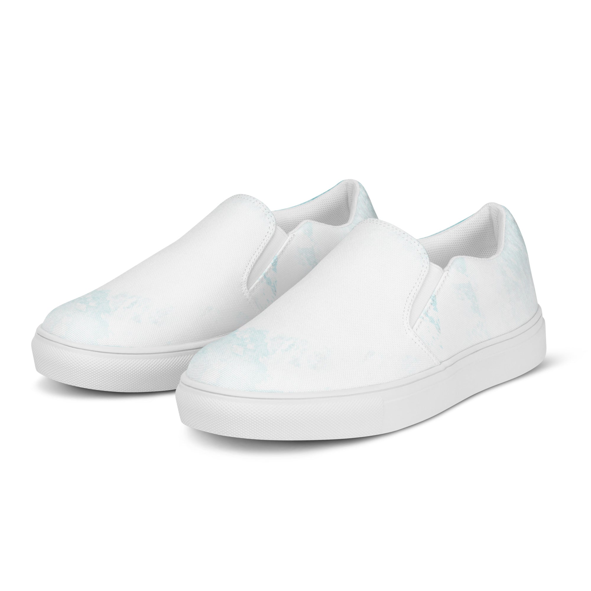 Womens slip-on canvas shoes featuring a subtle abstract ocean blue and white print, designed for comfort and style.