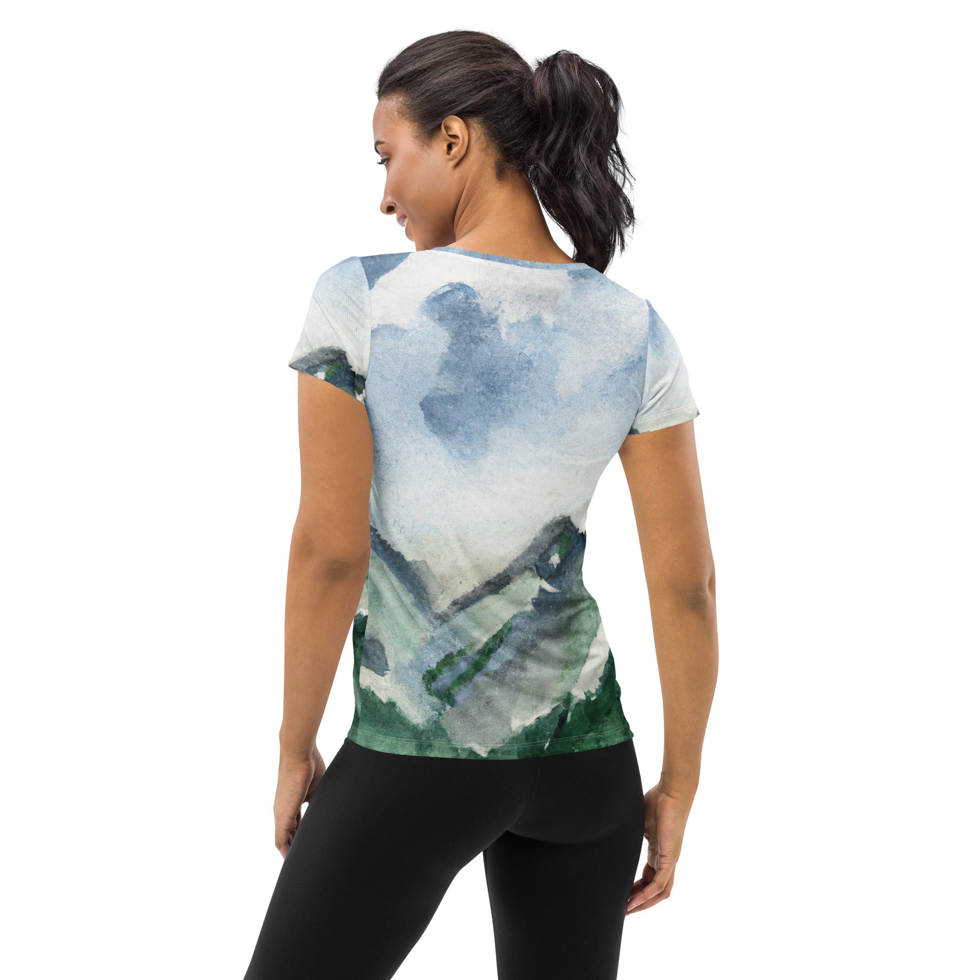 Women's Stretch Fit Athletic Sports T-shirt featuring a Green Mountainside Nature landscape print against a blue sky, designed for comfort and performance.