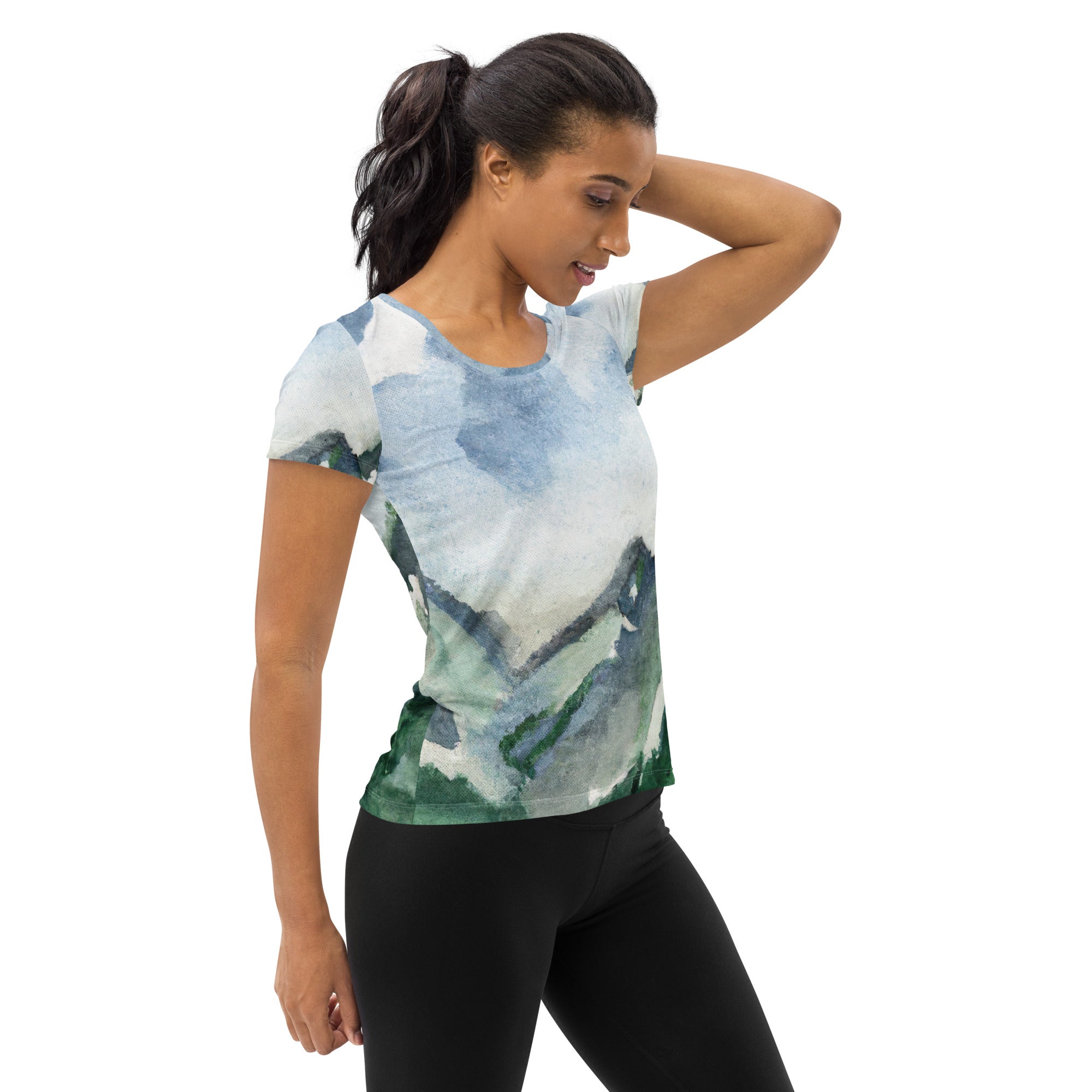 Women's Stretch Fit Athletic Sports T-shirt featuring a Green Mountainside Nature landscape print against a blue sky, designed for comfort and performance.
