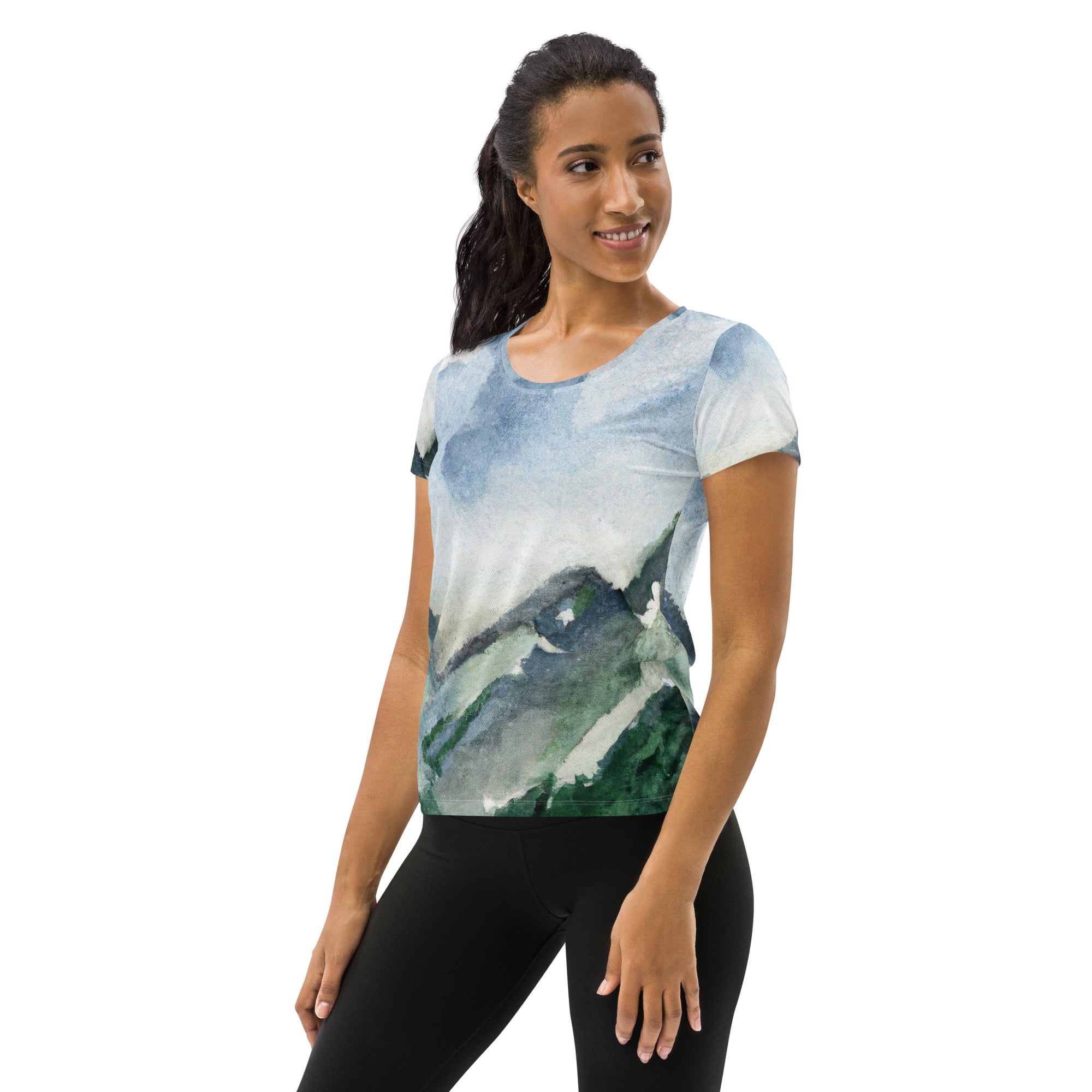 Women's Stretch Fit Athletic Sports T-shirt featuring a Green Mountainside Nature landscape print against a blue sky, designed for comfort and performance.