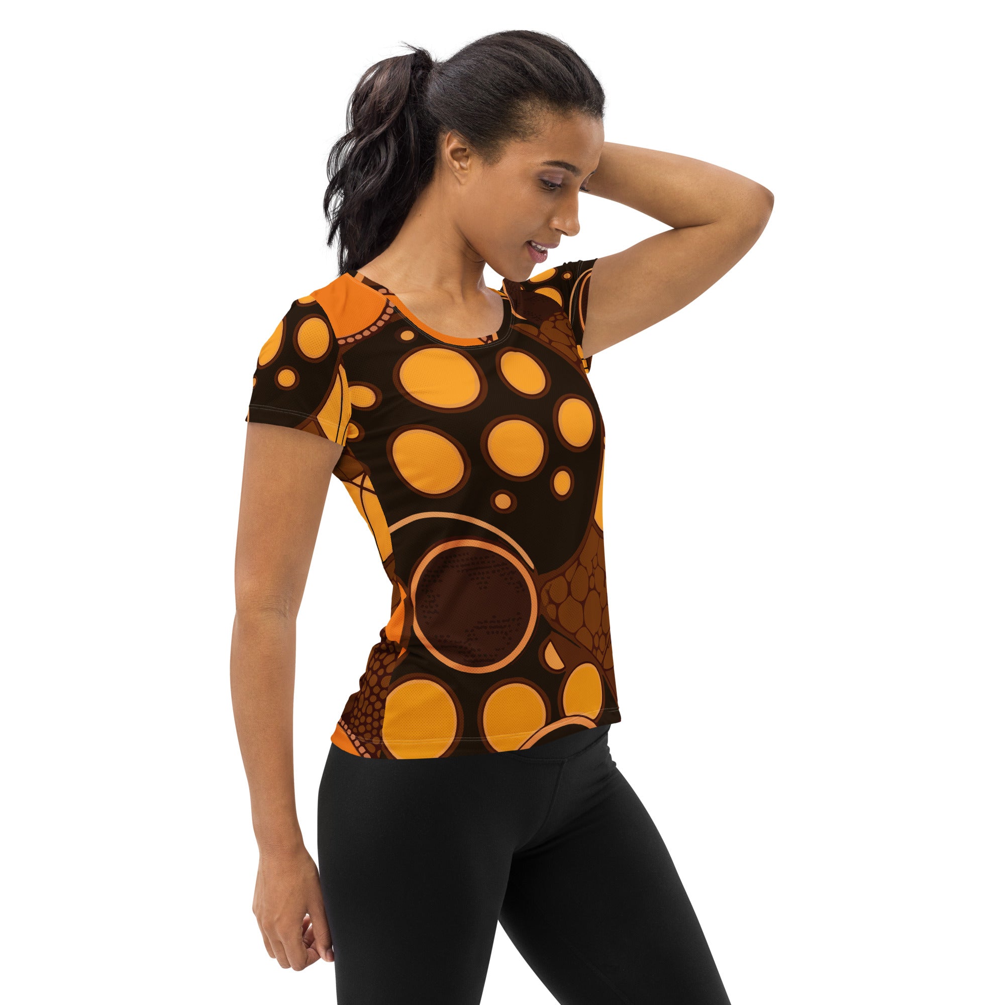 Women's Stretch Fit Athletic Sports T-shirt in orange and brown spotted print, showcasing its flexible fit and stylish design.