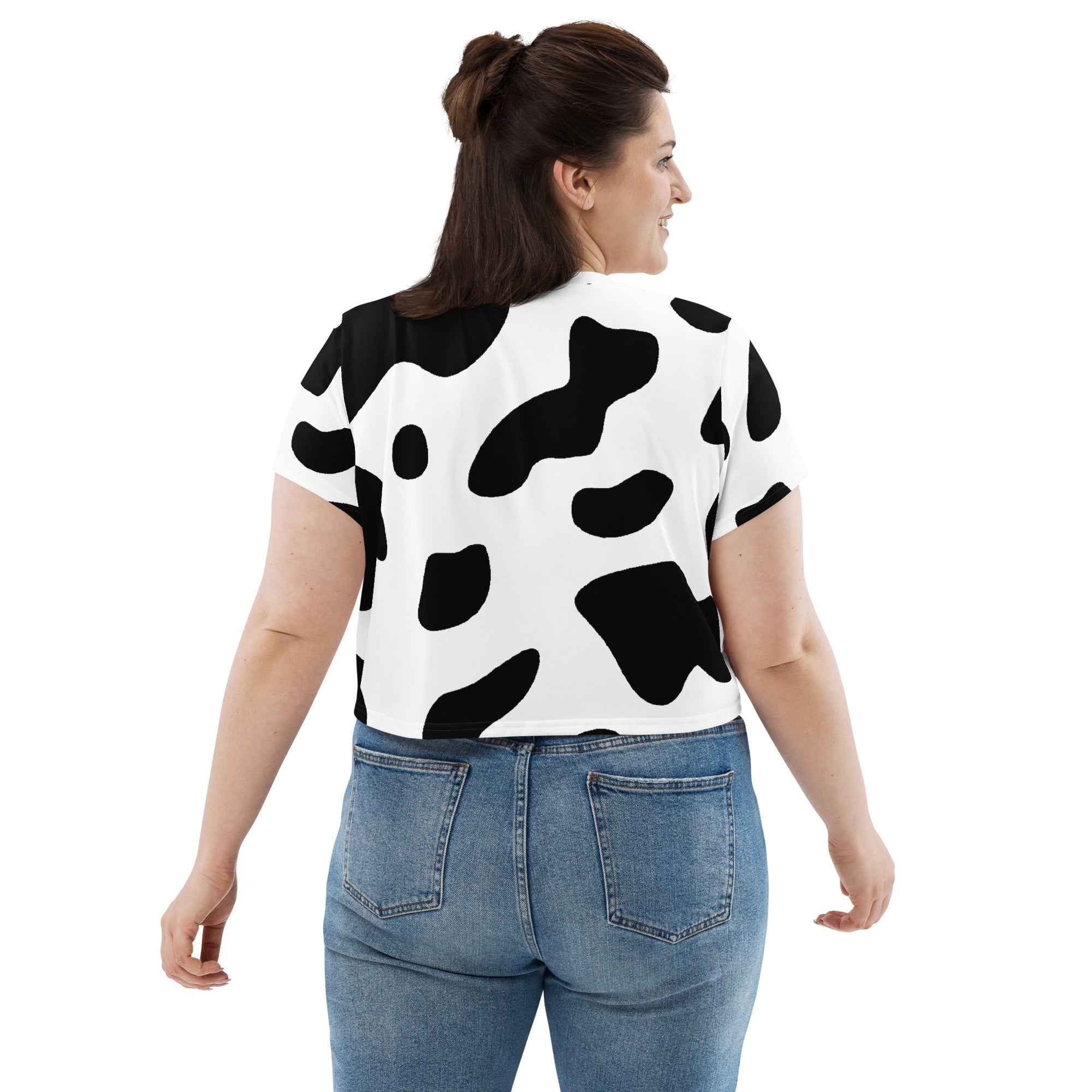 Women's Stretch Fit Crop Tee in Black White Cow Print, showcasing a stylish cropped design with short sleeves and a crew neckline.