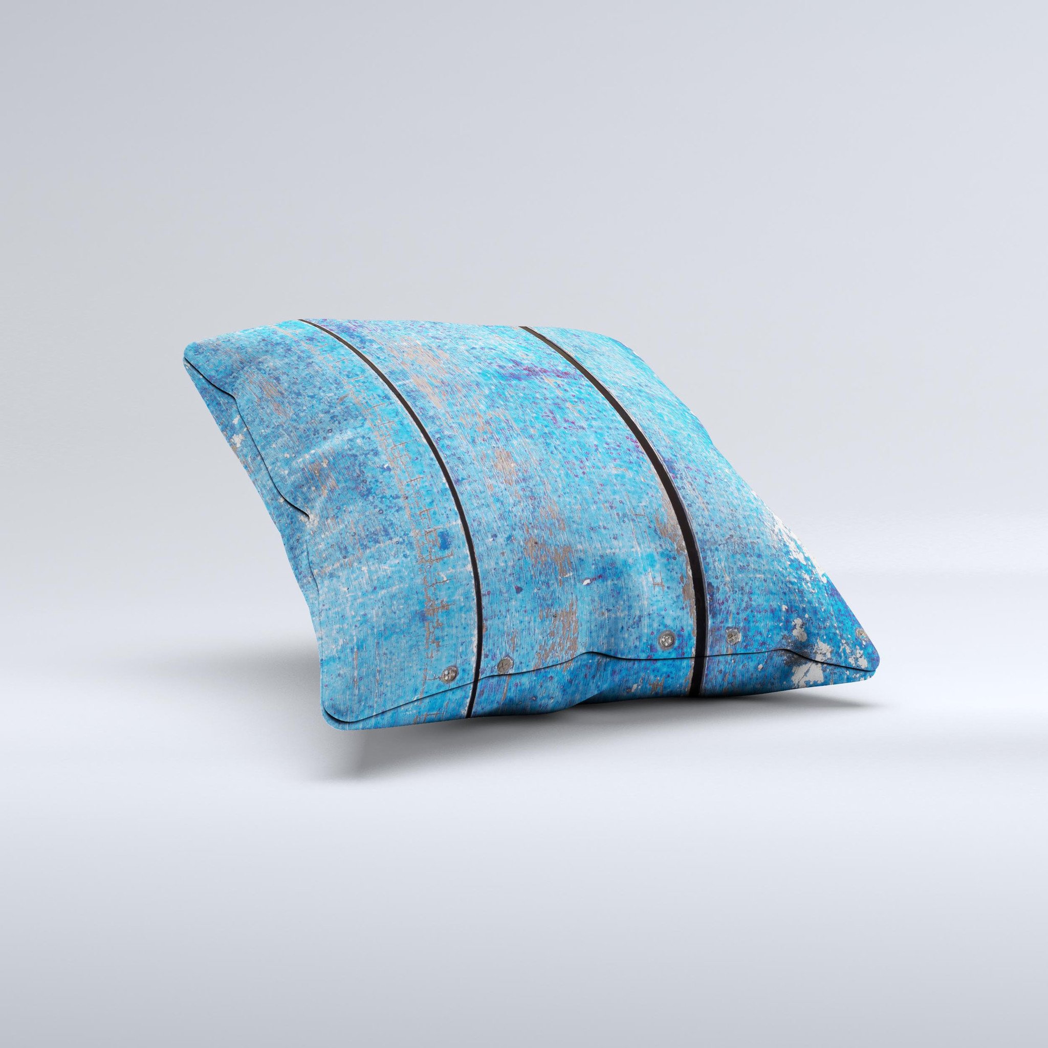Handcrafted decorative throw pillow featuring a worn blue paint design on wooden planks, showcasing unique imperfections and high-quality fabric.