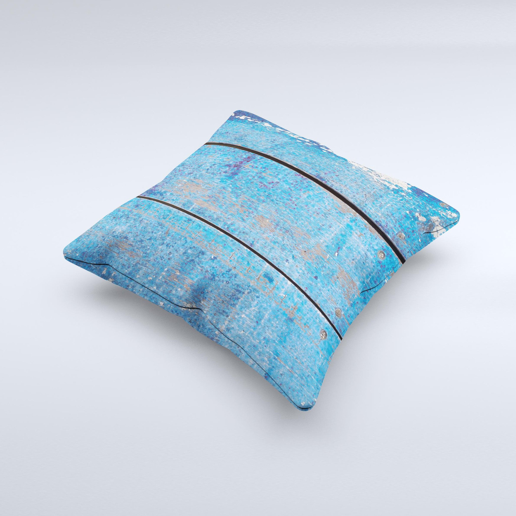 Handcrafted decorative throw pillow featuring a worn blue paint design on wooden planks, showcasing unique imperfections and high-quality fabric.