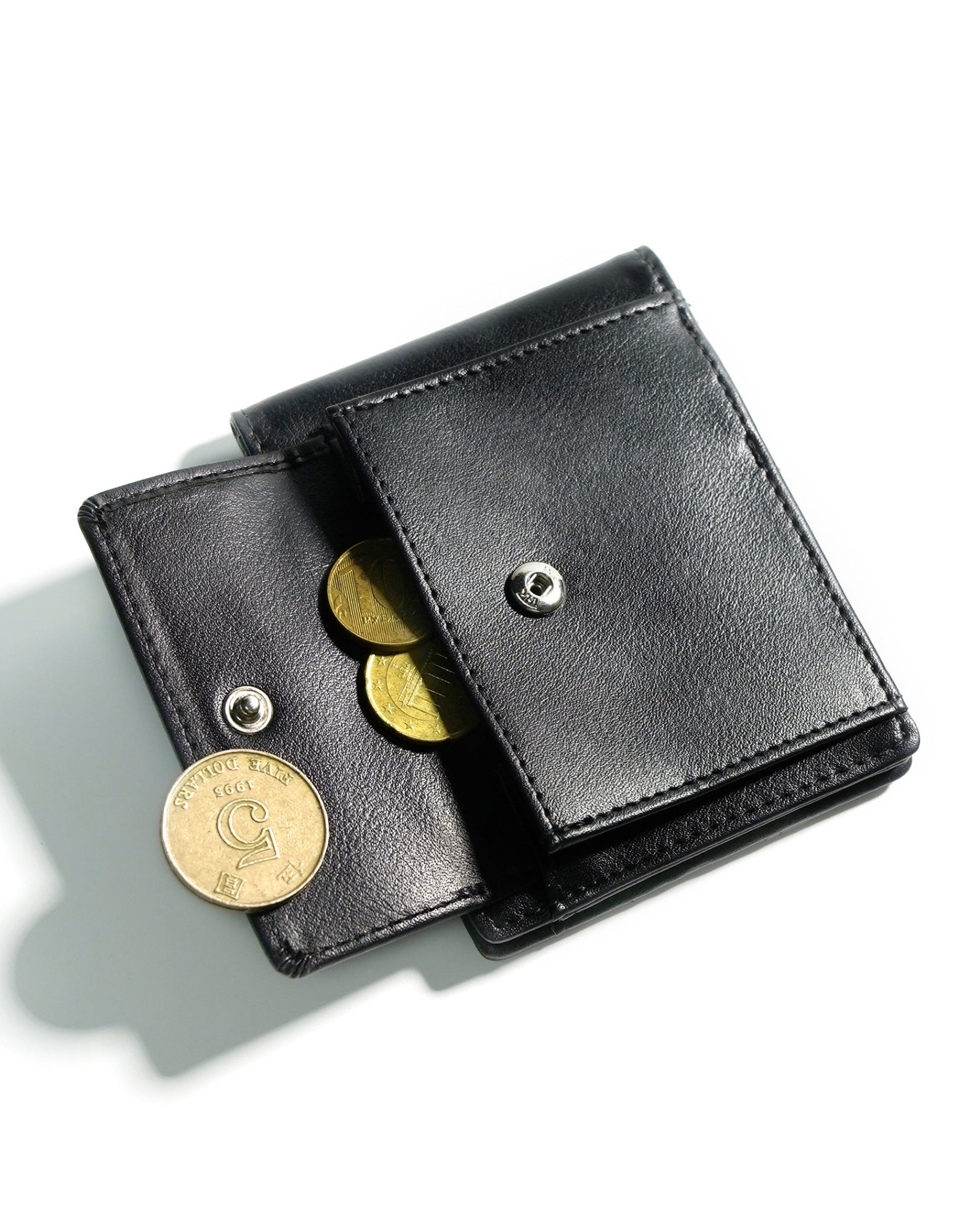 YAMBA Wallet I Black made from high-quality vegan leather, featuring a slim bifold design with card slots, money clip, and coin pocket.