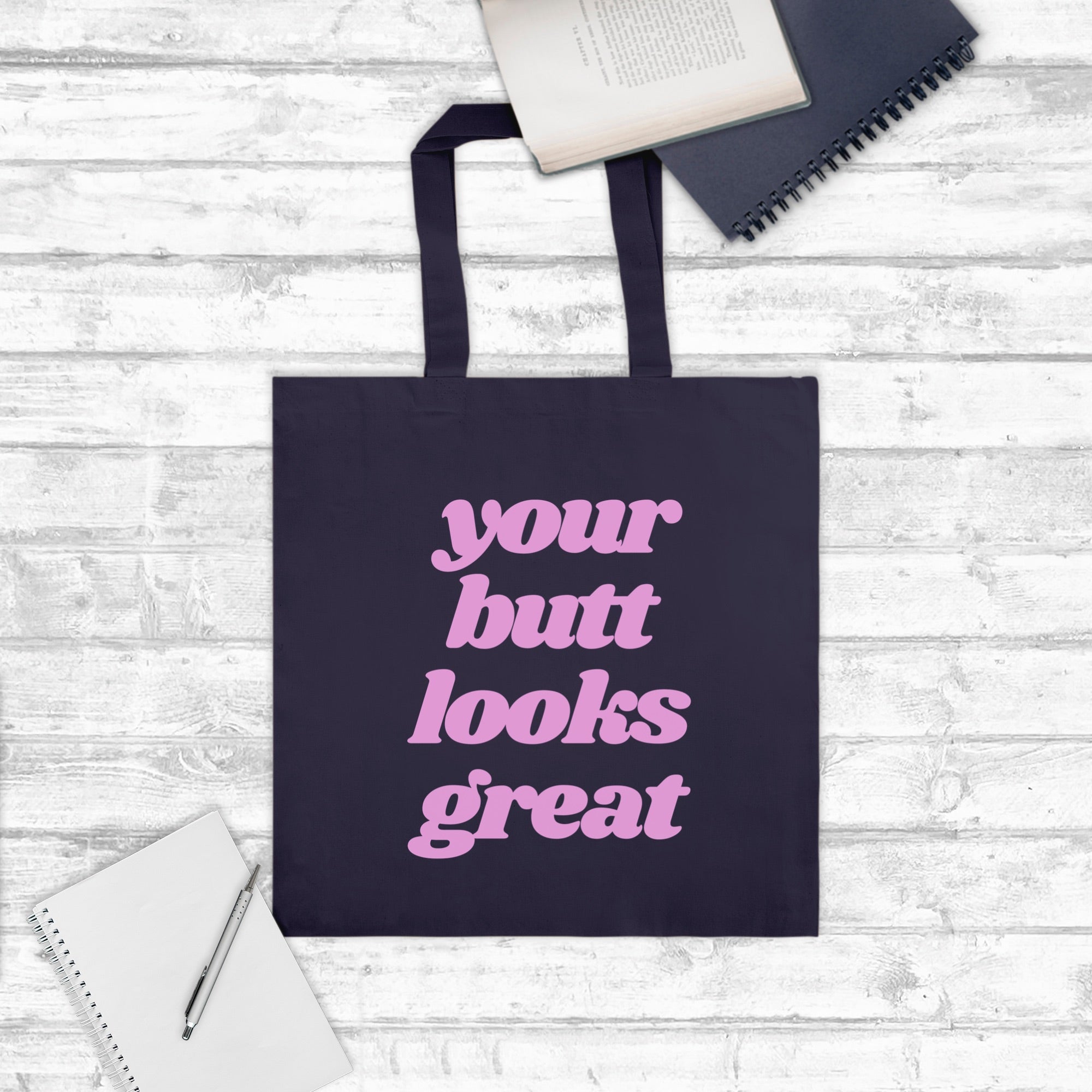 A stylish Your Butt Looks Great Tote Bag made of 100% cotton canvas, featuring a vibrant design and comfortable handles, perfect for shopping and travel.