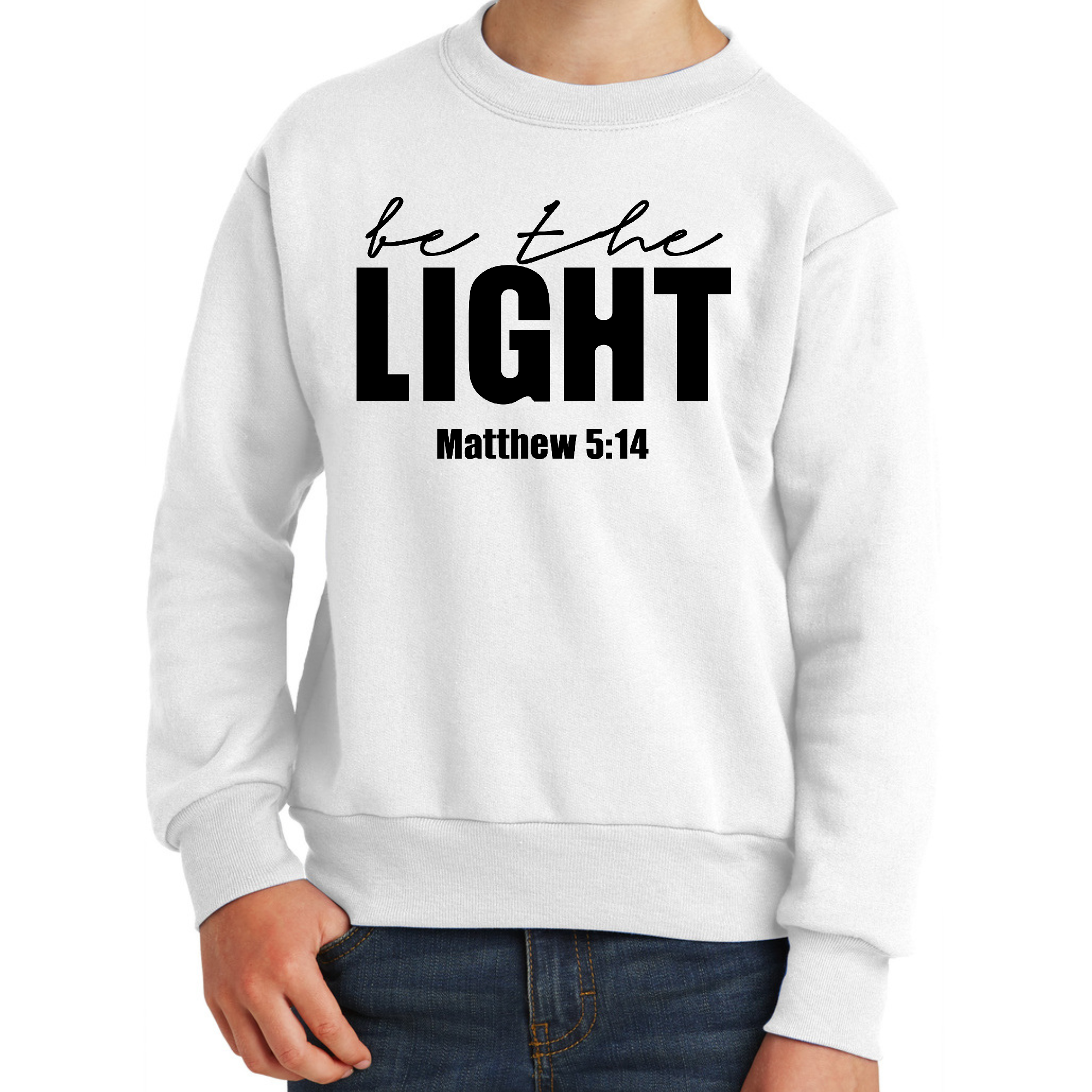 Youth Graphic Sweatshirt in black featuring 'Be The Light' inspirational art illustration, showcasing a comfortable crewneck design.
