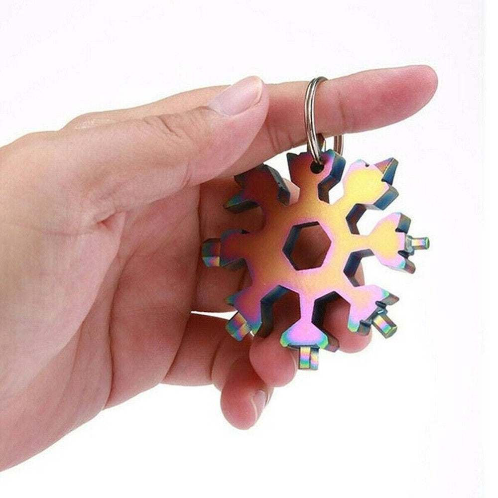 Three stainless steel snowflake-shaped multi-tools with various screwdrivers and hex wrenches, displayed with key rings.