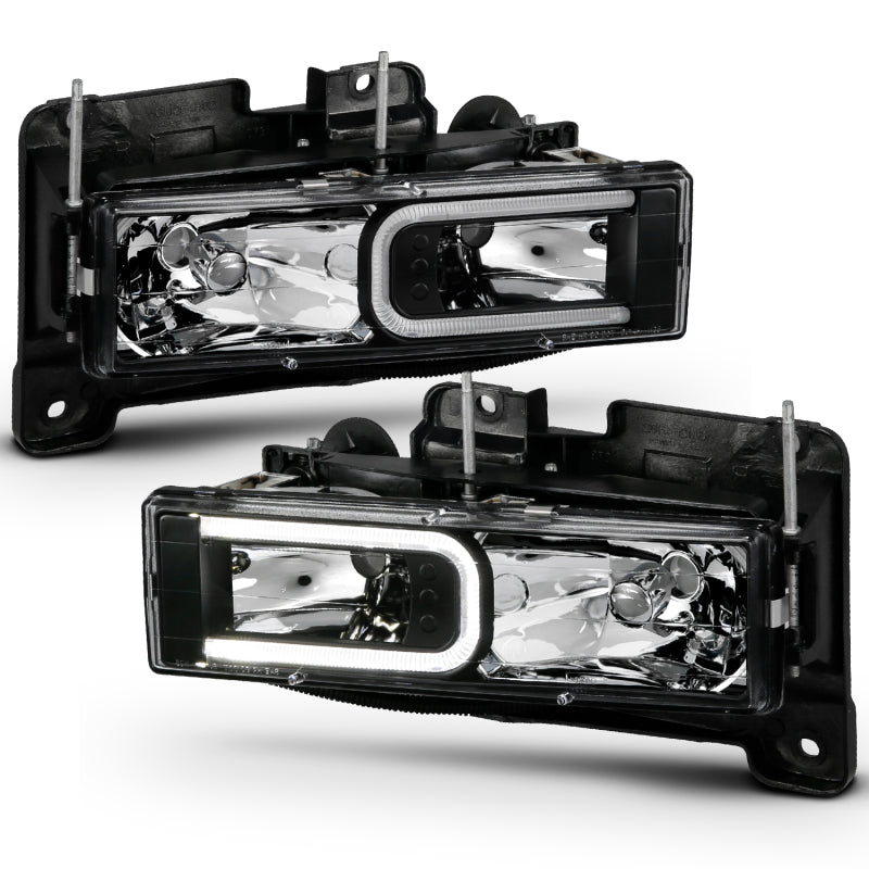 ANZO 1999-2000 Cadillac Escalade Crystal Headlights with a sleek black light bar design, enhancing vehicle visibility and style.