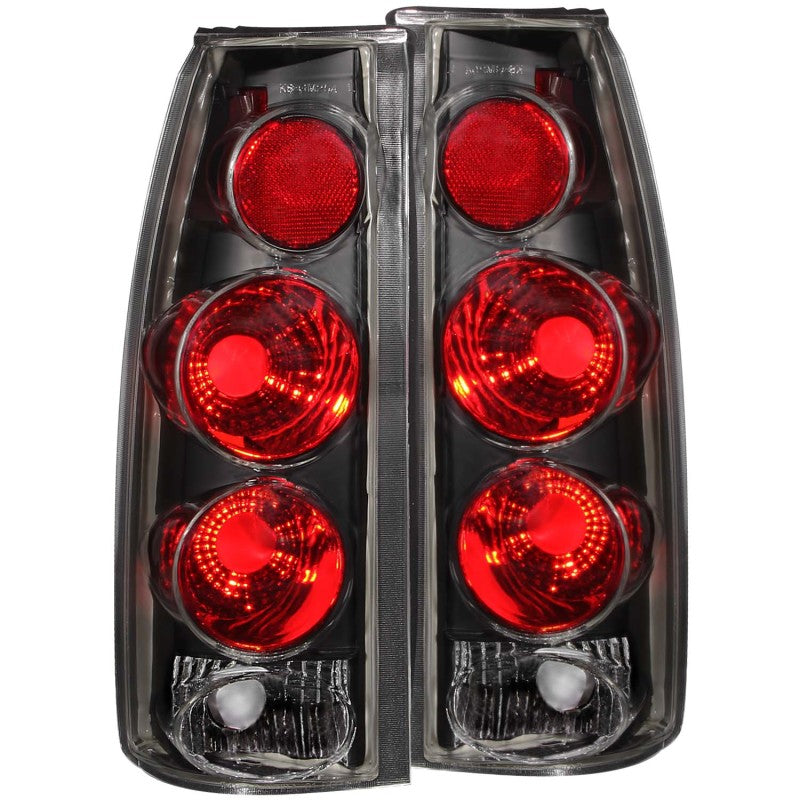 ANZO 1999-2000 Cadillac Escalade taillights featuring a sleek black housing and clear lens in a stylish 3D design.