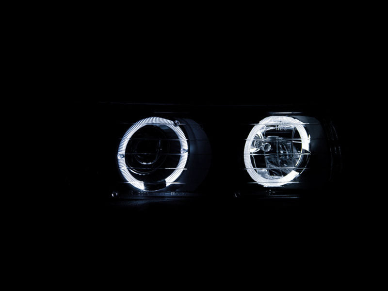ANZO 1999-2002 Chevrolet Silverado 1500 Projector Headlights with Halo, featuring clear lens and black housing for enhanced style and visibility.