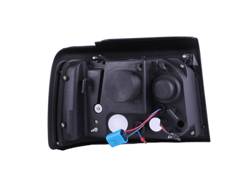 ANZO 1992-1996 Ford F-150 Projector Headlights with Halo Chrome and side marker lights, showcasing a sleek design and clear lens.