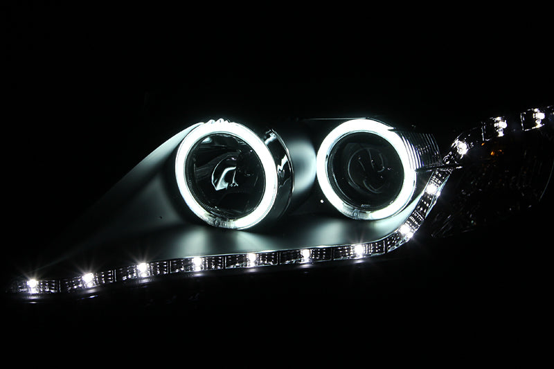 ANZO 2010-2011 Toyota Camry Projector Headlights with Halo in black housing, showcasing clear lens and stylish design.