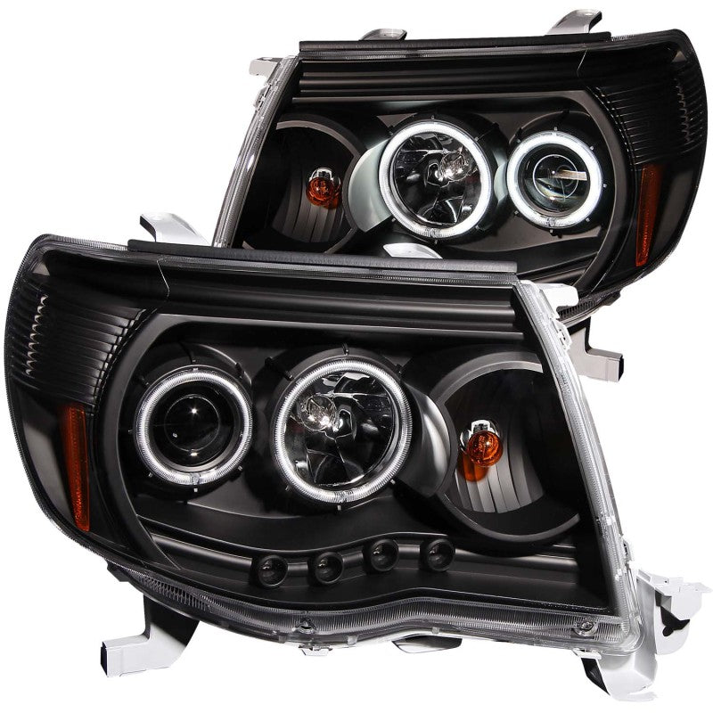 ANZO 2005-2011 Toyota Tacoma Projector Headlights with Halo in black housing, showcasing clear lens and stylish design.