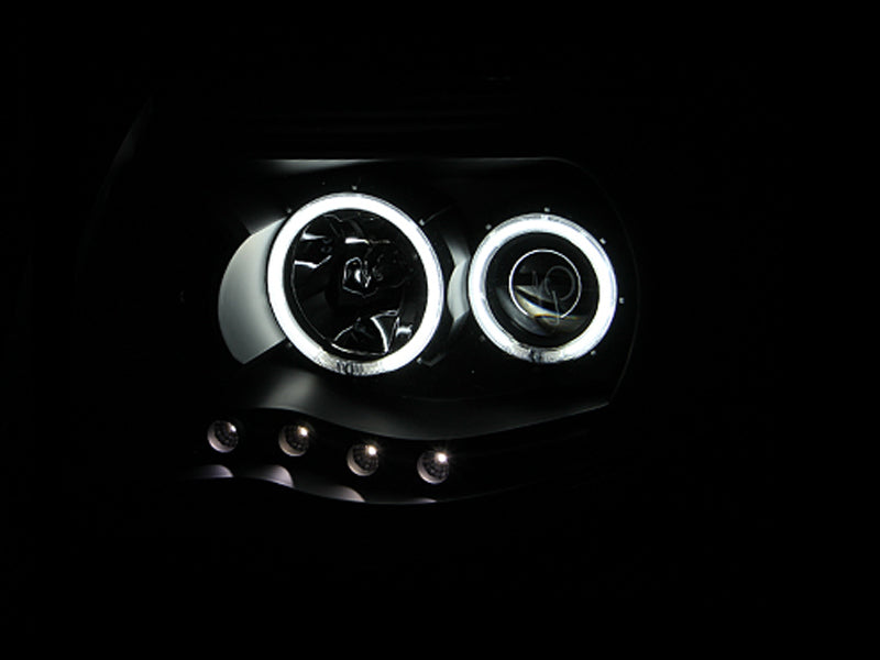 ANZO 2005-2011 Toyota Tacoma Projector Headlights with Halo in black housing, showcasing clear lens and stylish design.