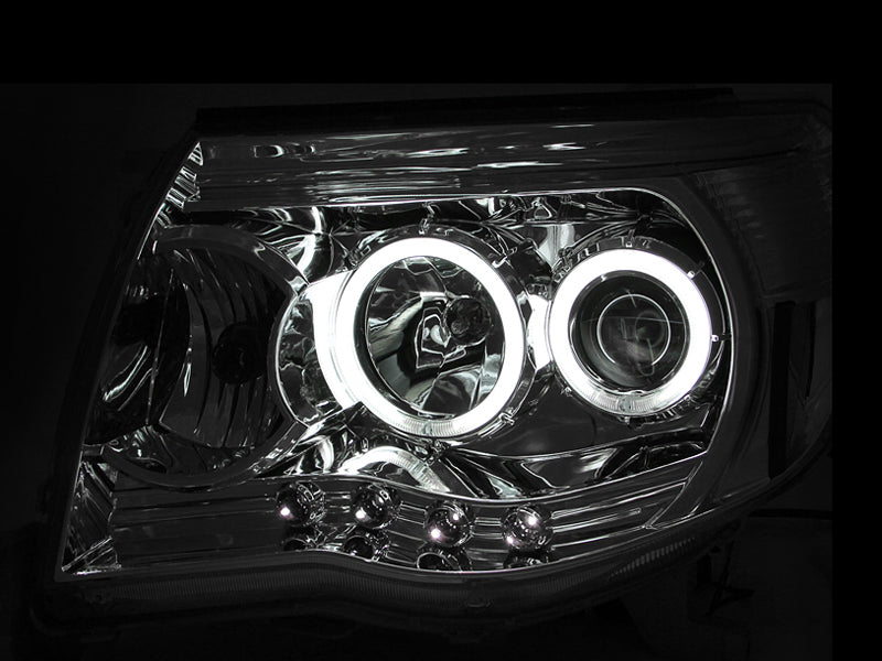 ANZO projector headlights with halos and chrome housing for 2005-2011 Toyota Tacoma, showcasing clear lens and stylish design.