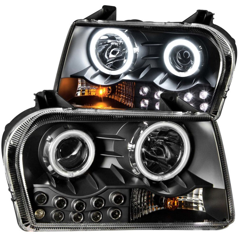 ANZO 2005-2010 Chrysler 300 projector headlights with halo black design, showcasing clear lens and black housing.
