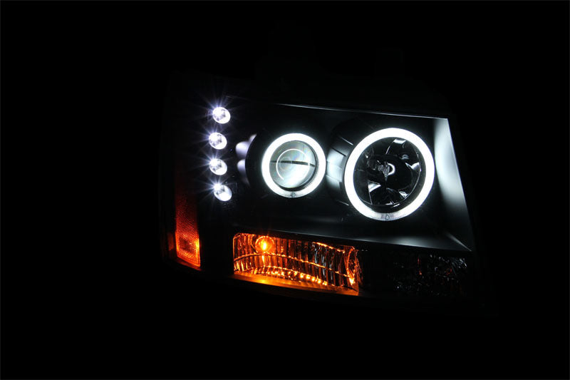 ANZO 2007-2013 Chevrolet Avalanche projector headlights with halo feature and black housing, showcasing modern design and clear lens.