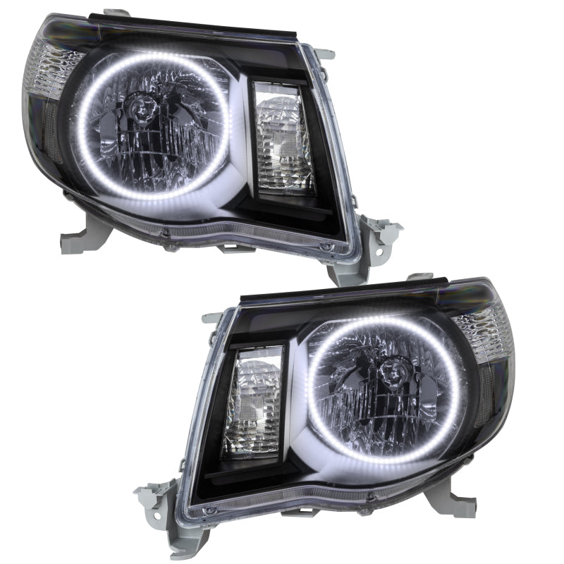Oracle 05-11 Toyota Tacoma SMD headlights in black housing with white halo rings, showcasing a modern design.