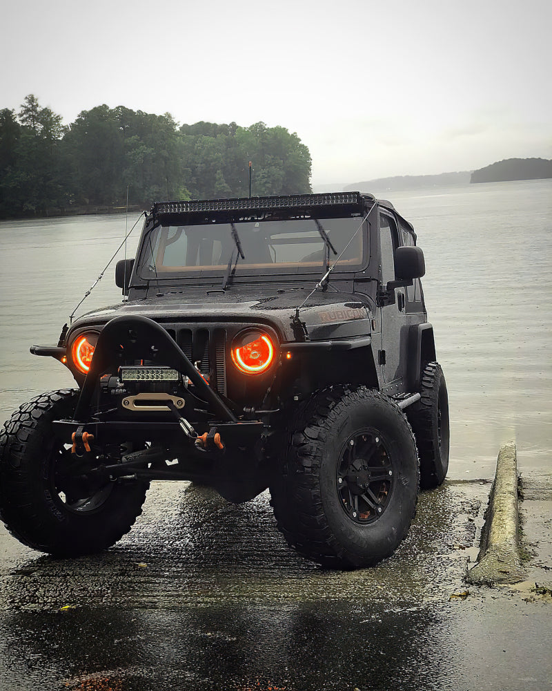 Oracle 7in High Powered LED Headlights with Black Bezel and Amber accents, showcasing rugged design and advanced lighting technology.