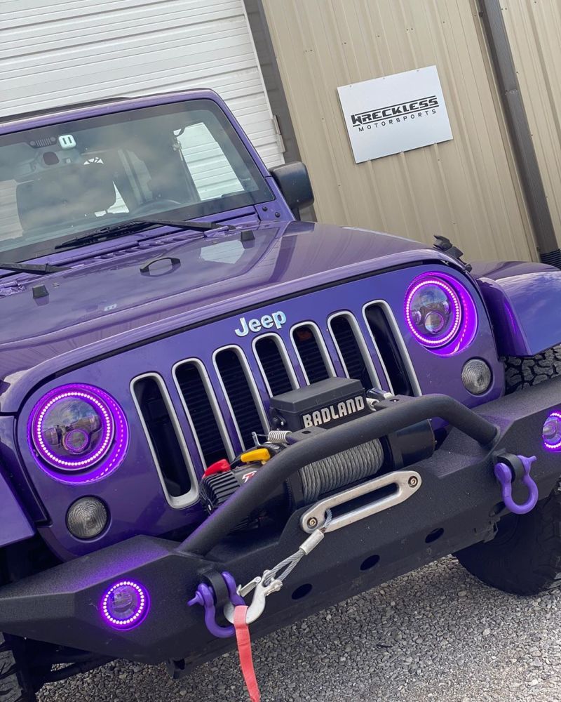 Oracle 7in High Powered LED Headlights with black bezel and customizable color halos, designed for Jeep Wranglers and off-road vehicles.