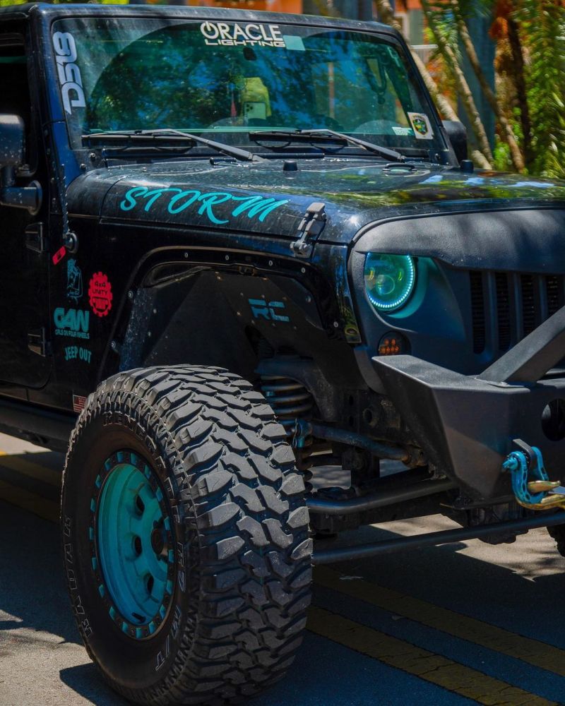 Oracle 7in High Powered LED Headlights with black bezel, showcasing dynamic color features and rugged design for Jeep Wrangler and off-road vehicles.