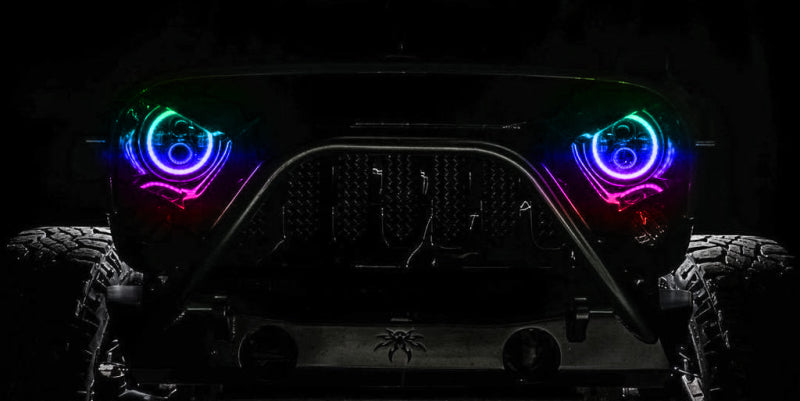 Oracle 7in High Powered LED Headlights with black bezel, showcasing dynamic color features and rugged design for Jeep Wrangler and off-road vehicles.