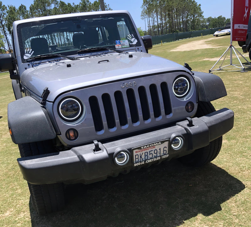 Oracle 7in High Powered LED Headlights with black bezel, showcasing dynamic color features and rugged design for Jeep Wrangler and off-road vehicles.