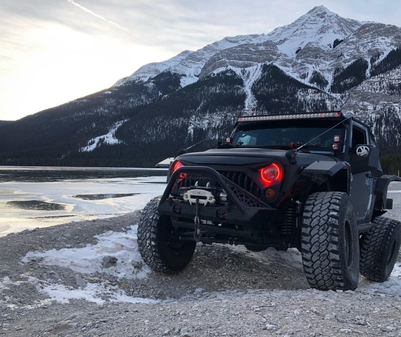 Oracle 7in High Powered LED Headlights with black bezel, showcasing dynamic color features and rugged design for Jeep Wrangler and off-road vehicles.