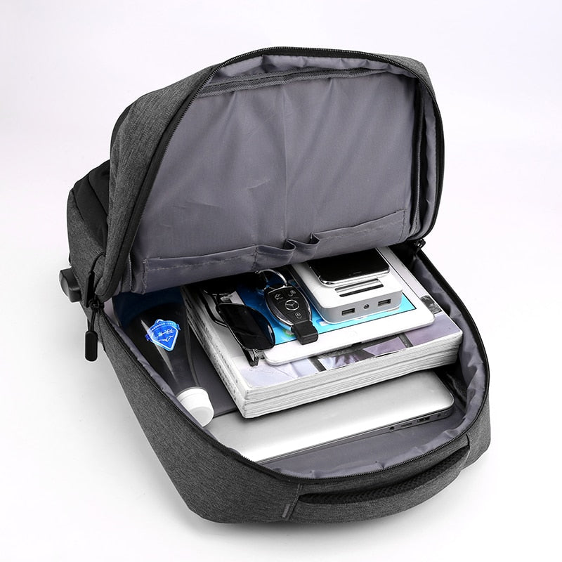 Multifunctional waterproof backpack for men with USB charging port, featuring a stylish patchwork design and multiple compartments.