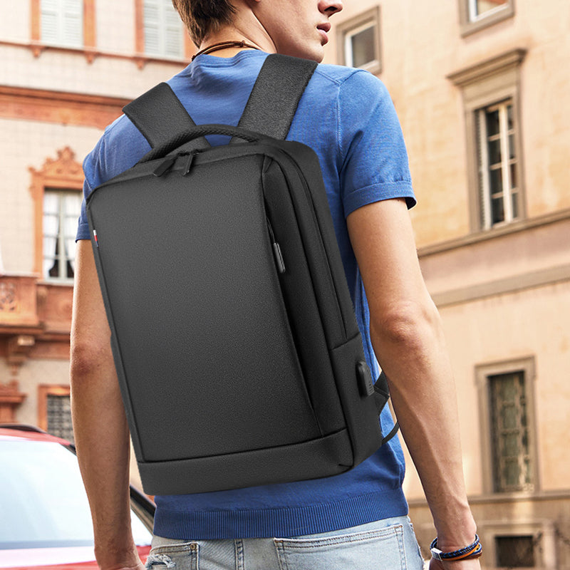 A stylish waterproof Oxford cloth backpack for men, featuring a USB charging port and multiple compartments for laptops and daily essentials.