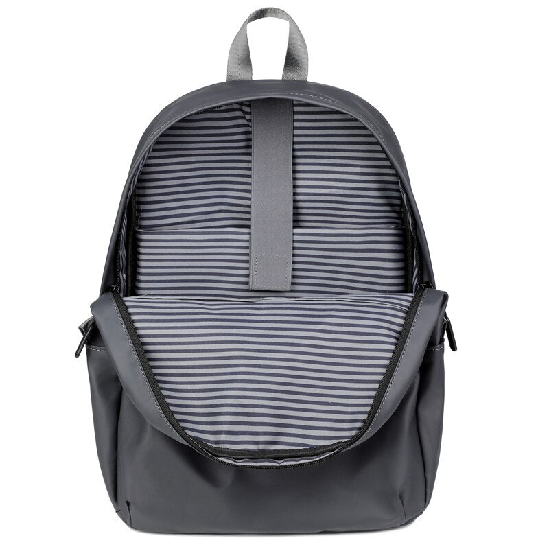 A stylish business backpack for men made of high-quality nylon, featuring multiple pockets and designed to hold a 15.6-inch laptop.