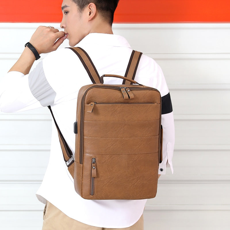 Large waterproof PU leather business backpack for men, featuring multiple compartments and a stylish design, perfect for carrying laptops and essentials.
