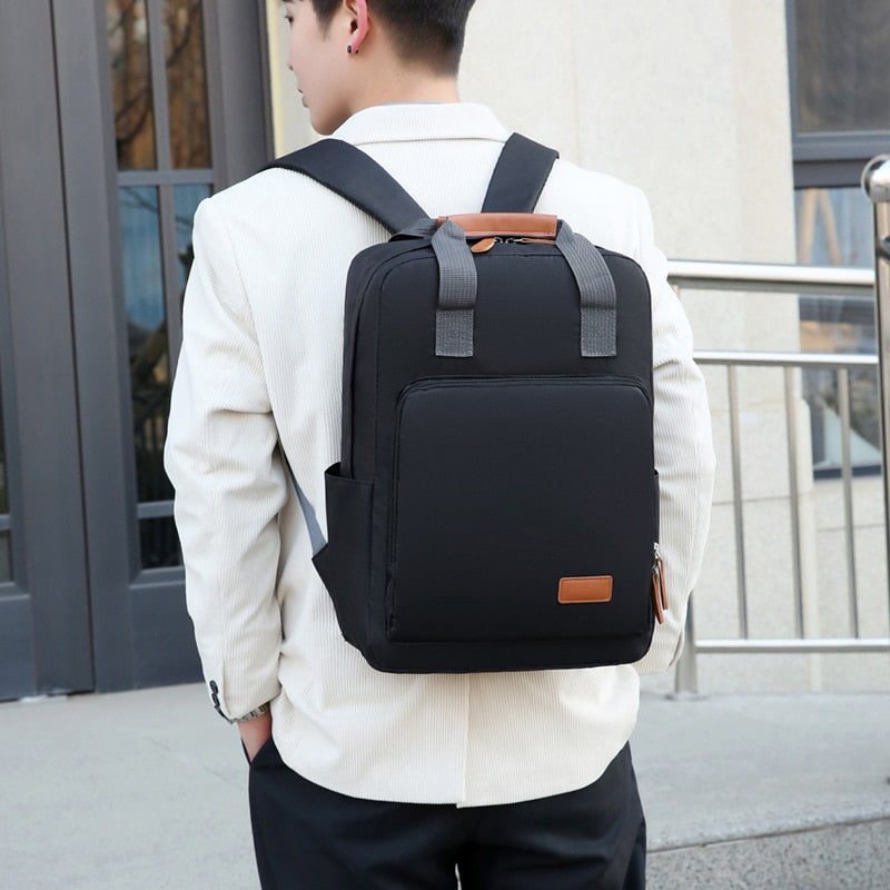 Business casual backpack for men made of waterproof Oxford cloth, featuring multiple compartments and a stylish solid design.