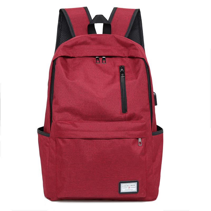 Fashion Business Backpack made of durable Oxford cloth with USB charging interface, featuring a zipper opening and spacious compartments.