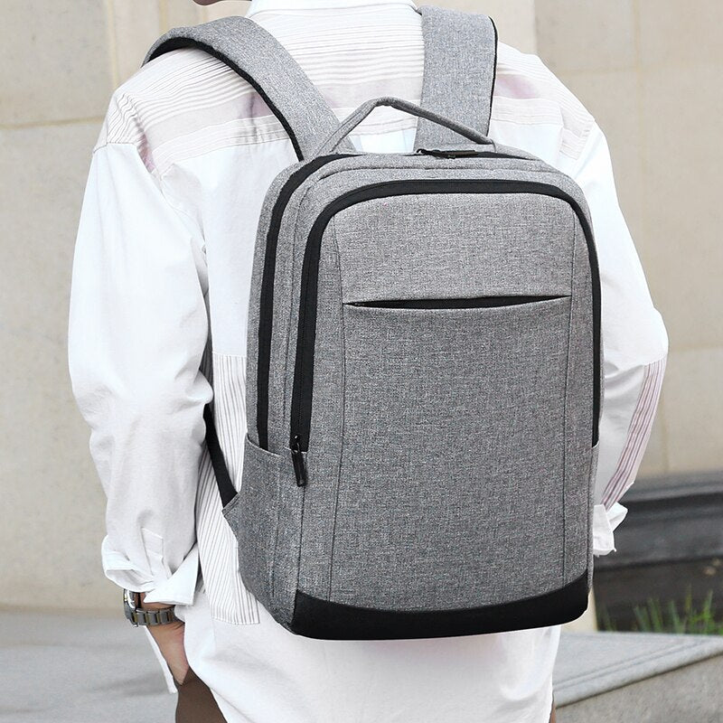Fashion Men's Backpack made of waterproof Oxford cloth, featuring a large capacity and reflective stripe, ideal for business and casual use.